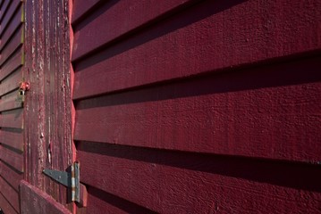 Abstract shed, U.K. Red hut in sunlight.