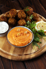 Traditional homemade hummus, falafel and chickpea served with spices on table. Jewish Cuisine.