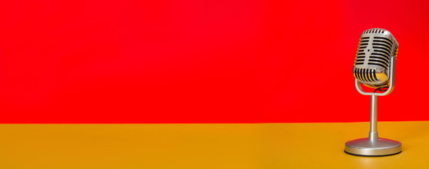 Close up Retro Microphone sound concept with red and yellow background banner