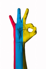 Obraz premium Hand making Ok sign, Ecuador flag painted as symbol of best quality, positivity and success - isolated on white background