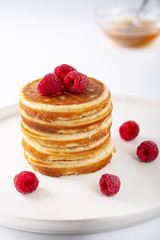 Fresh homemade pancakes with berries and syrup