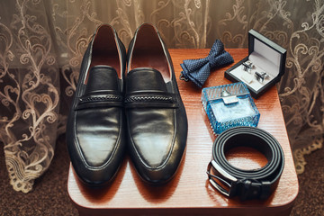 different accessories of a businessman for creating a style of a people lie on a wooden background