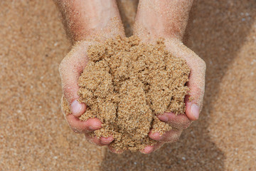 Hands holding sand