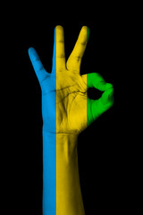 Hand making Ok sign, Gabon flag painted as symbol of best quality, positivity and success -...