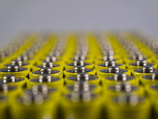 Huge number of AA batteries of yellow color. Batteries for use in the different equipment