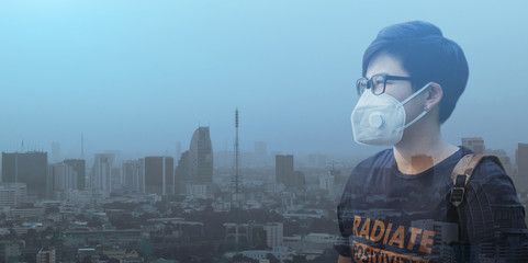 Asian Man Wearing N95 PM 2.5 Protective Mask Anti Air Pollution on Dust Smog City Background Bad Environment Banner Cover Size