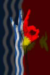 Hand making Ok sign, Kiribati flag painted as symbol of best quality, positivity and success - isolated on flag background