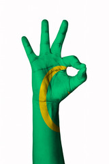 Hand making Ok sign, Mauritania flag painted as symbol of best quality, positivity and success - isolated on white background