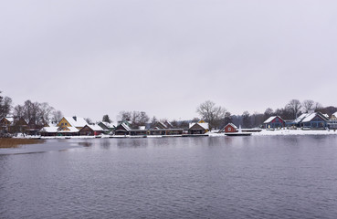 View on houses by the river side in winter