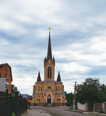 Fototapeta na wymiar Lutheran church is located in Old Town of Lutsk, the main tourist, historical and architectural part of the city. Translation of text on sign from Ukrainian: 'House of the Gospel'