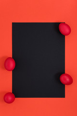 Blank black card on a coral background, color of the year. Easter frame.