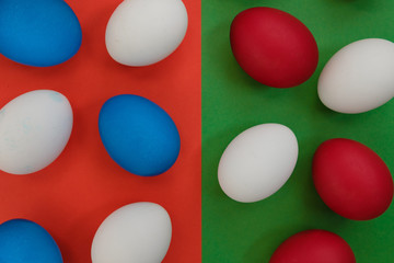 Colored eggs on a bright background. Top view with copy space.