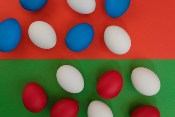 Colored eggs on a bright background. Top view with copy space.