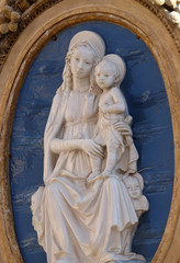 Image of Virgin Mary with baby Jesus on the facade of a palace in Rome, Italy 