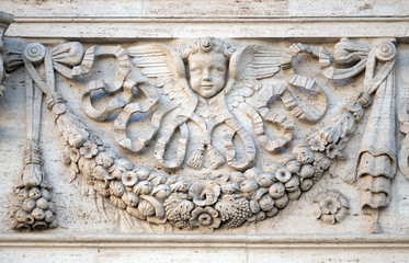 Angel, bass relief on the facade of Santa Maria in Via church in Rome, Italy  