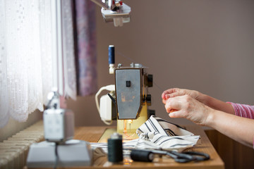 woman hands using sewing machine on a sewing manufacture, sewing process