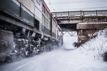 diesel locomotive quickly travels on snow-covered railways