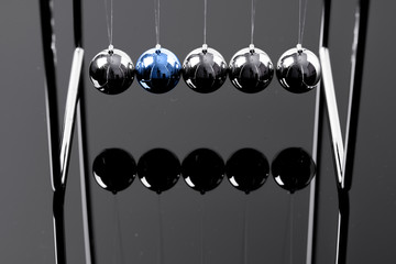 Newtons Cradle balancing balls, business concept in studio