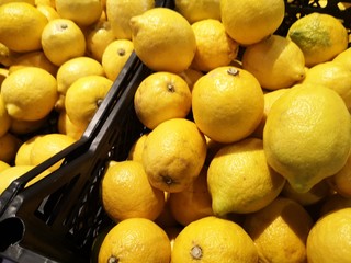 Boxes with fresh lemons in the supermarket. 