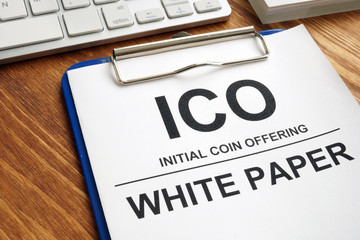 ICO initial coin offering white paper documents with clipboard.