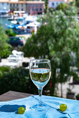 White wine of Provence, France, served cold with soft goat cheese on outdoor terrace in wine glass