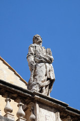 Fototapeta na wymiar Statue of Apostle on the church dei Santi XII Apostoli in Rome, Italy 