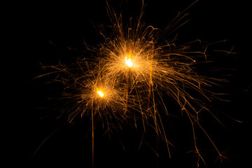 Bengal fire. New year sparkler candle on black background
