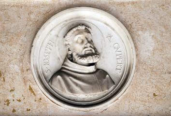 Saint Joseph of Cupertino, bass relief in portico of church dei Santi XII Apostoli in Rome, Italy 