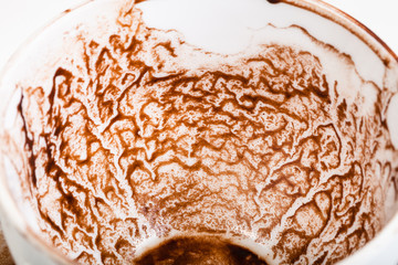 pattern of dried carob sediments on wall of cup