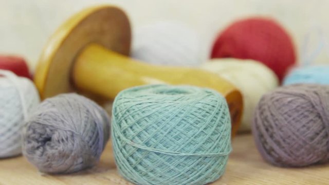 Various threads, needles and the wooden  mushroom for manual darning