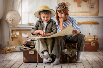 Boys in images traveler and pilot play in his room
