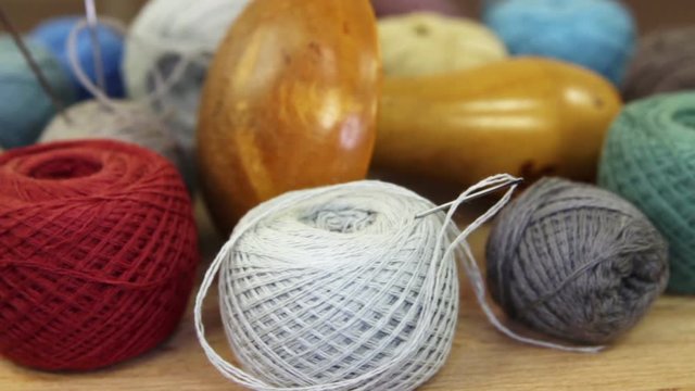 Various threads, needles and the wooden  mushroom for manual darning