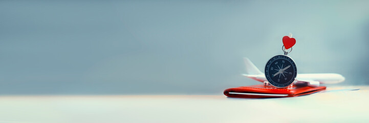 Time to Travel. Idea for tourism with an airplane, passport and tickets and compass with heart on a light background. Concept on the theme of flights.