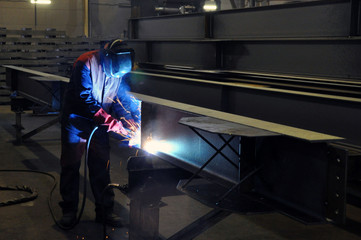 Fototapeta na wymiar electric welder brews steel at the factory