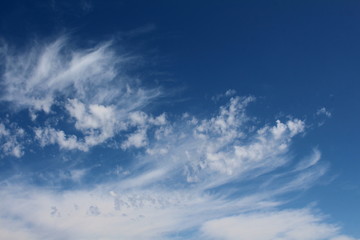 Naklejka na ściany i meble Wispy cirrus clouds against a blue sky.