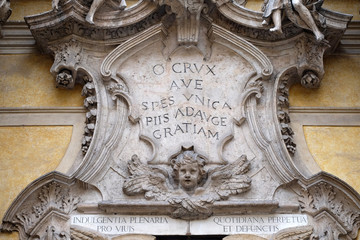 Angels and epigraph: Hail, the only hope, add more grace to the pious, facade of Santa Maria Maddalena Church in Rome, Italy 