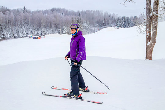 Older Man Alpine Skiing In The Snow In Winter.