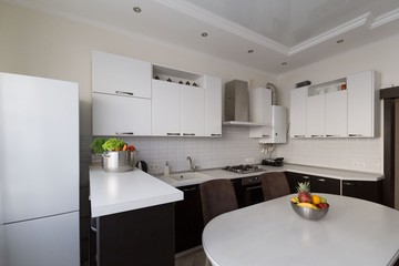 Interior. Kitchen modern, white, brown, beige color, fruits and vegetables