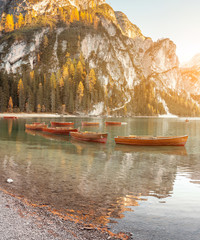 Boats waiting for tourist rent in Braies lake in Dolomites Alps