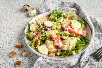 Fresh caesar salad with chicken breast, lettuce and tomatoes. Delicious spring salad