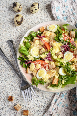 Fresh caesar salad with chicken breast, lettuce and tomatoes. Delicious spring salad