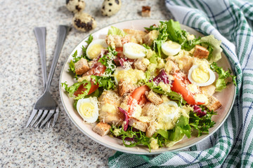 Fresh caesar salad with chicken breast, lettuce and tomatoes. Delicious spring salad