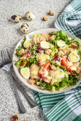 Fresh caesar salad with chicken breast, lettuce and tomatoes. Delicious spring salad