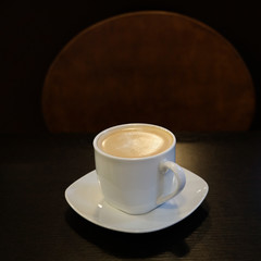 Cup of hot aromatic coffee on the table