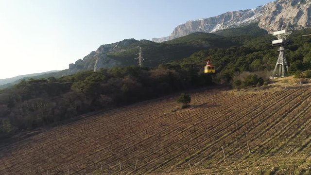Aerial view on elevator in blue sky on mountain. The cable car