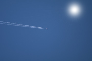 airplane in the sky,sun,jet,trail,white,fly,speed, vapor, transportation, trace, transport, smoke, 