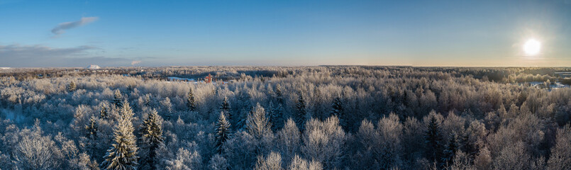 Aerial view of a beautiful sunset in the winter forest. 