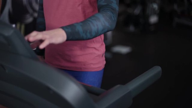 Handsome sporty man training on a treadmill.
