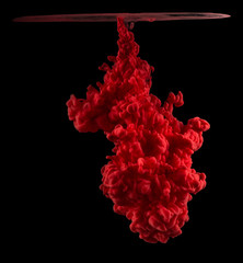 Swirling colorful drops cloud. Color splashes of ink isolated on black background. Abstract paint...