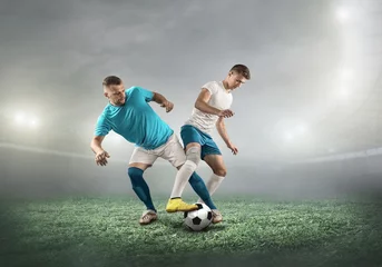 Foto op Canvas Caucasian soccer Players in dynamic action with ball in a professional sport game play on the laptop in football under stadium © Andrii IURLOV